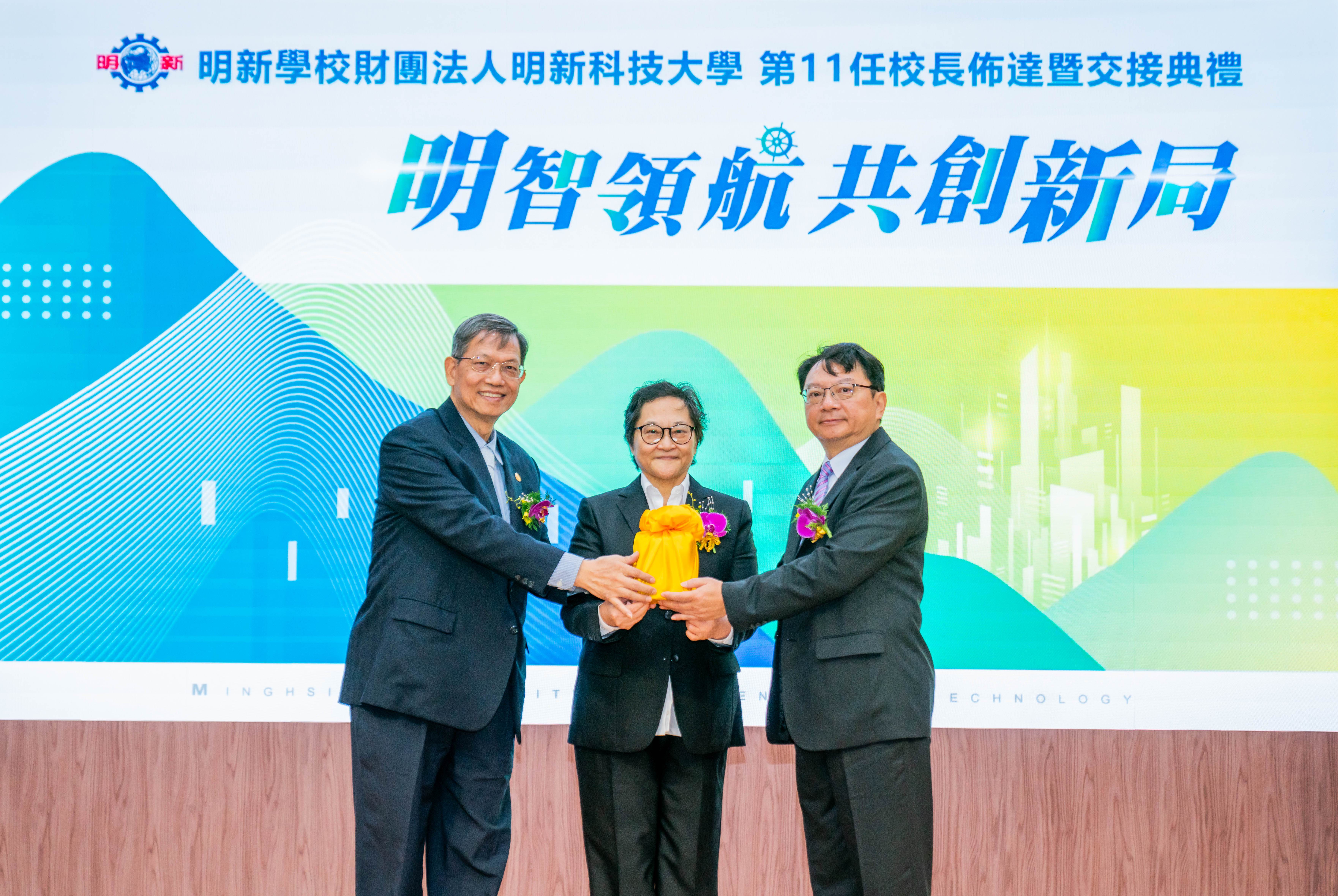明新科大今(16日)天舉行任校長交接，由郝碧蓮董事長(中)見證，呂明峯教授(右)由卸任校長林啟瑞教授(左)接下印信，出任第11任校長。（圖／明新科技大學提供）