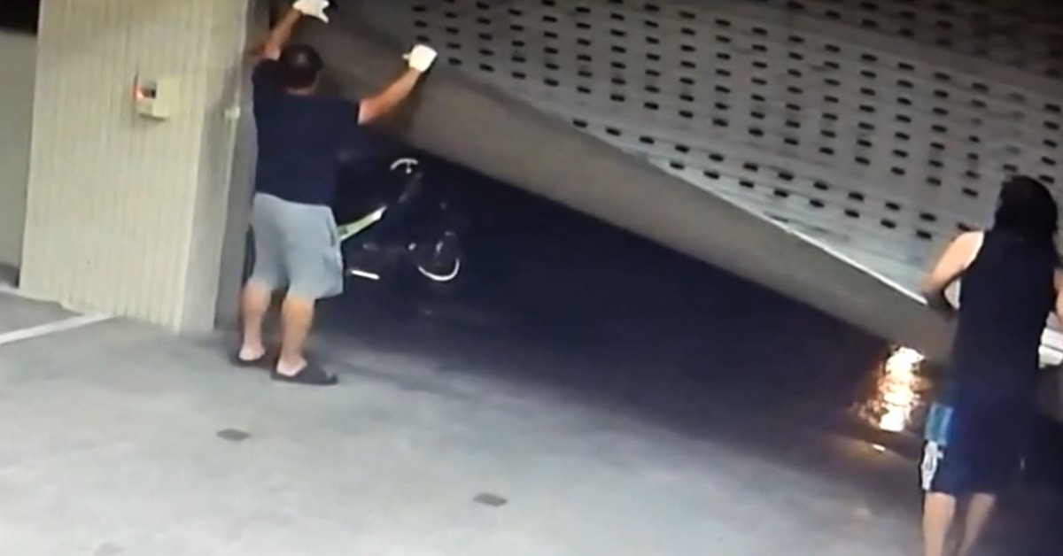 住戶靠人力拉住被吹飛的鐵門。（圖／東森新聞）