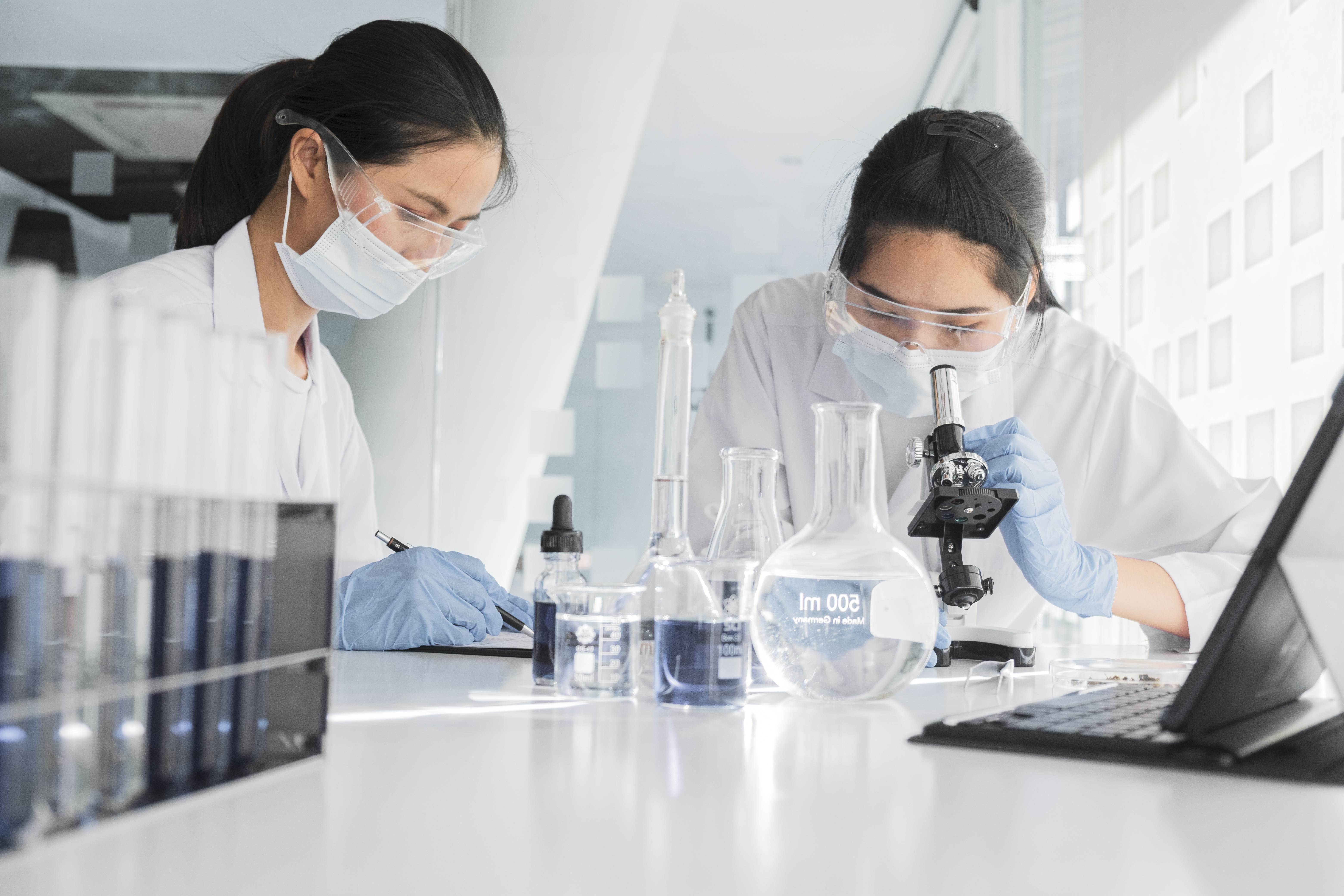 front-view-asian-women-working-together-chemical-project