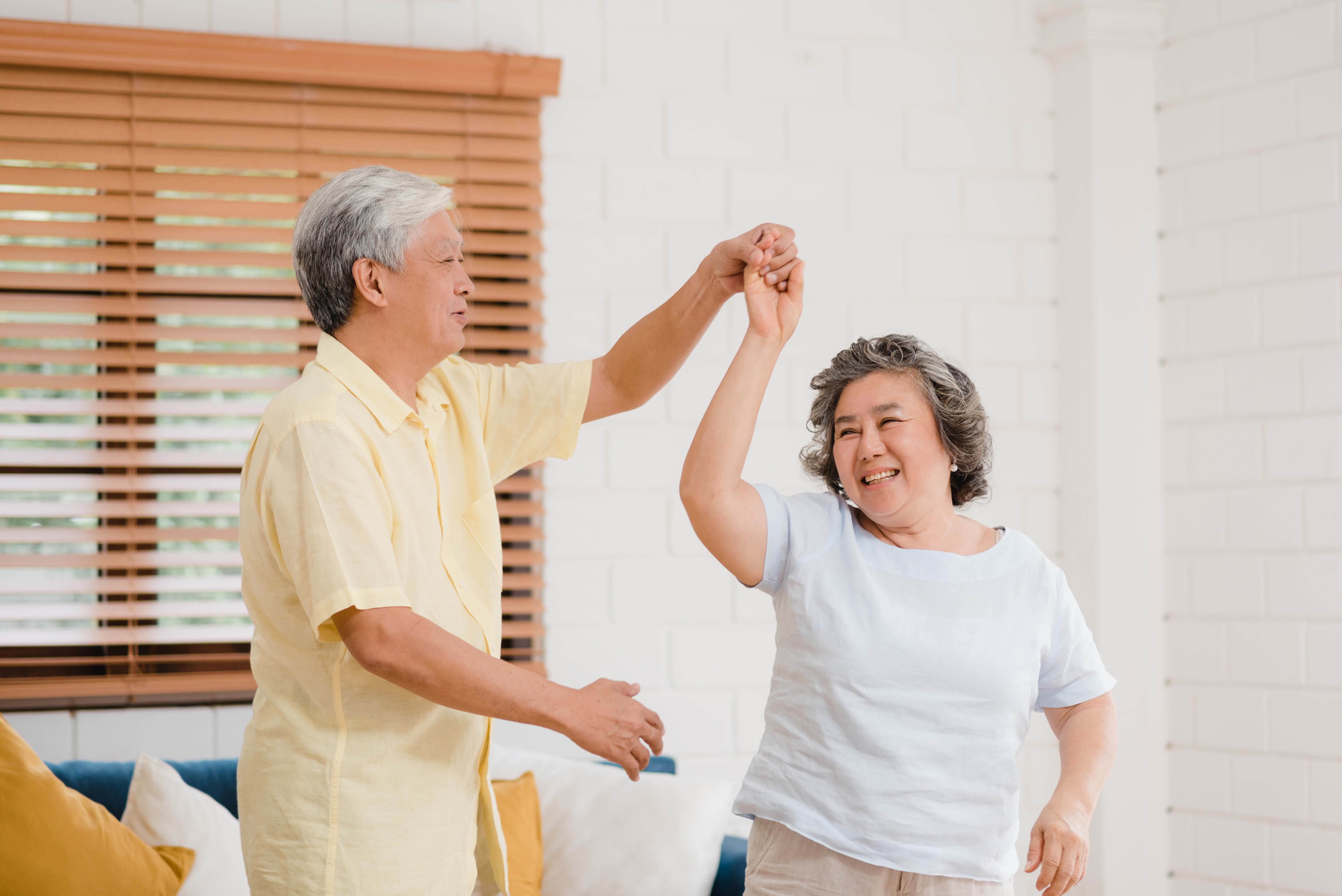 asian-elderly-couple-dancing-together-while-listen-music-living-room-home-sweet-couple-enjoy-love-moment-while-having-fun-when-relaxed-home